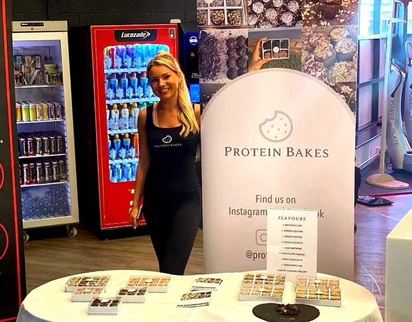 Sophie, founder of Protein Bakes, at a tasting stand